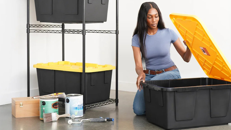 Person sorts through their things using Greenmade Storage Bins.
