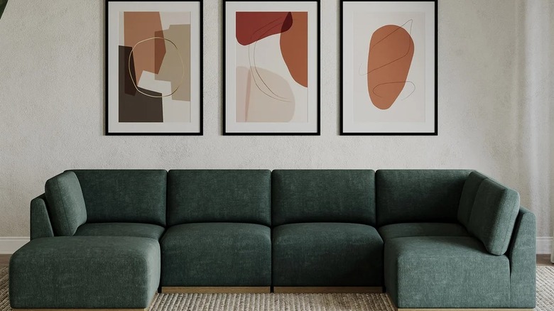 A large green-colored sectional in a living room