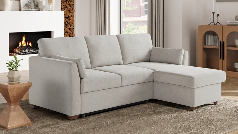 A small couch with a chaise on the side in a living room