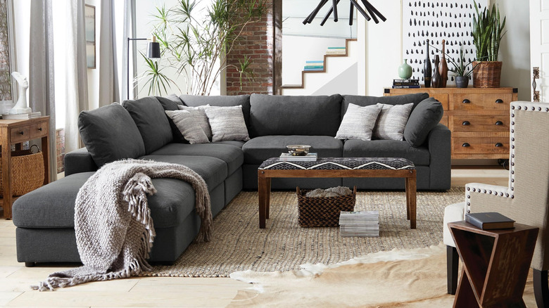 A smiling couple moving their new couch in