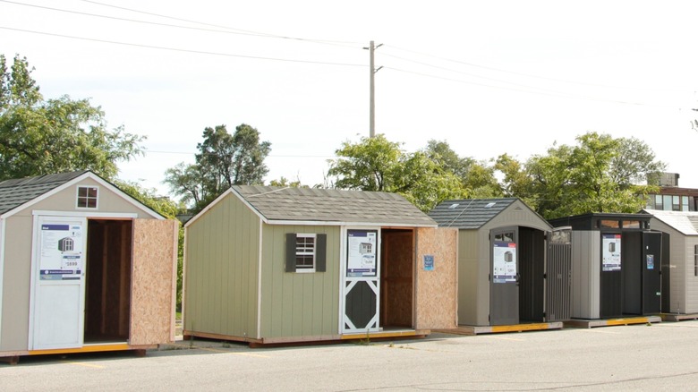 Garden sheds for sale in a parking lot outside of a store