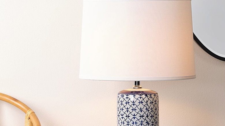 Olina Ceramic Table Lamp on side table with mirror in background