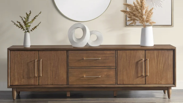 Puerta Del Sol TV Console with decorative dried grasses in white vases on top