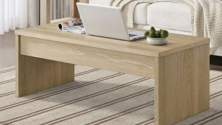 Whitlee Lift-Top Coffee Table in living room with sofa in background and decorations