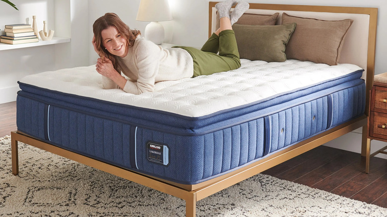 Woman laying on a Kirkland Signature by Stearns & Foster 14.5" Pillow Top Lakeridge Mattress