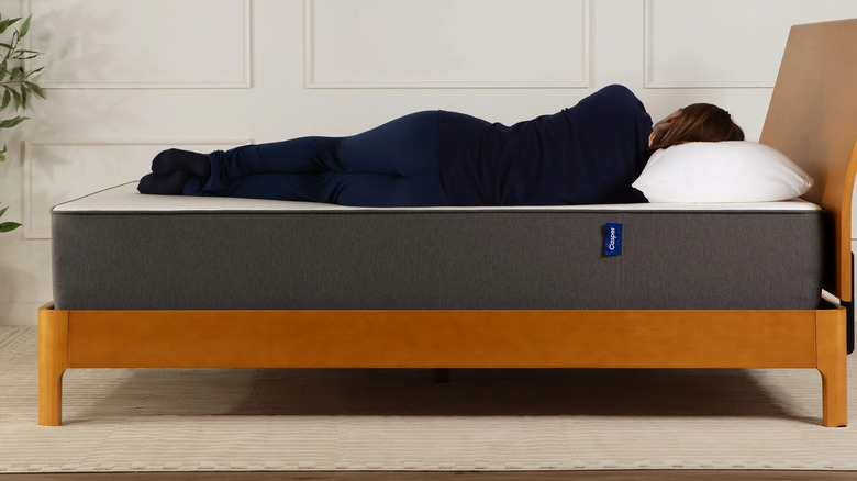 A personal laying on their side on a Casper Cooling Select 12" Memory Foam Mattress