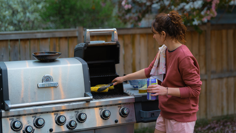 Woman using an outdoor grill