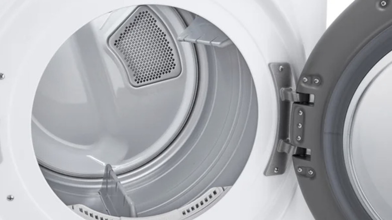 An empty dryer with an open door and shiny interior