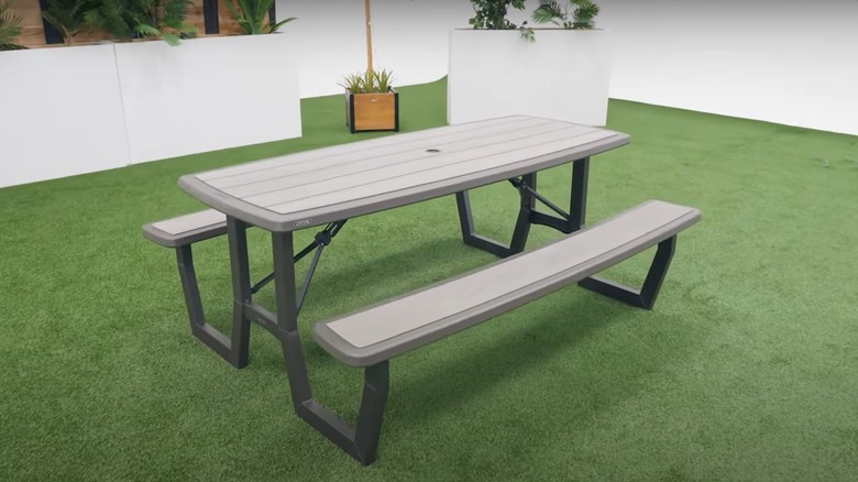 The Costco lifetime assembly picnic table rests on some faux grass
