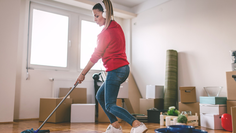 A young woman cleaning up wooden floors