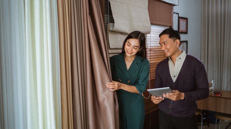 Two people shopping for curtains