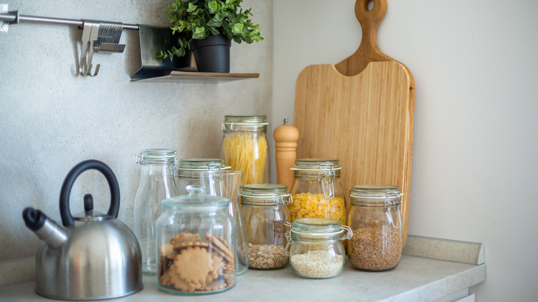 Kitchen counter with canisters, jars, and cutting boards next to each other