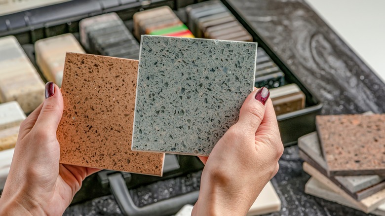 woman holding two countertop choices