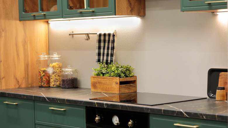Kitchen with laminate marble countertops and green cabinets
