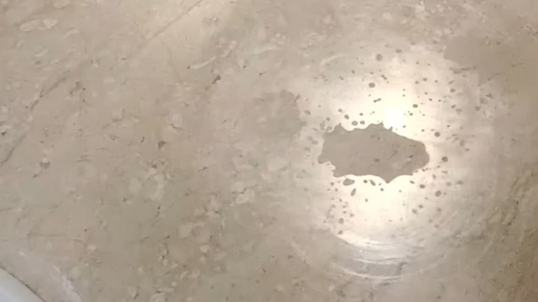 closeup on marble countertop with etch marks from chemical damage