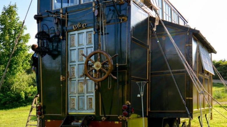 Black tiny home on wheels with eclectic accents