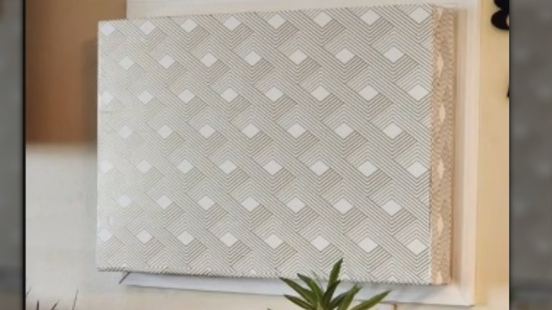 Internal AC unit covered with foam and wallpaper