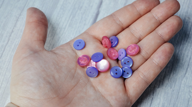 Woman holding a handful of buttons
