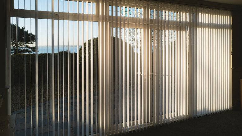 Blinds covering large sliding glass doors in home