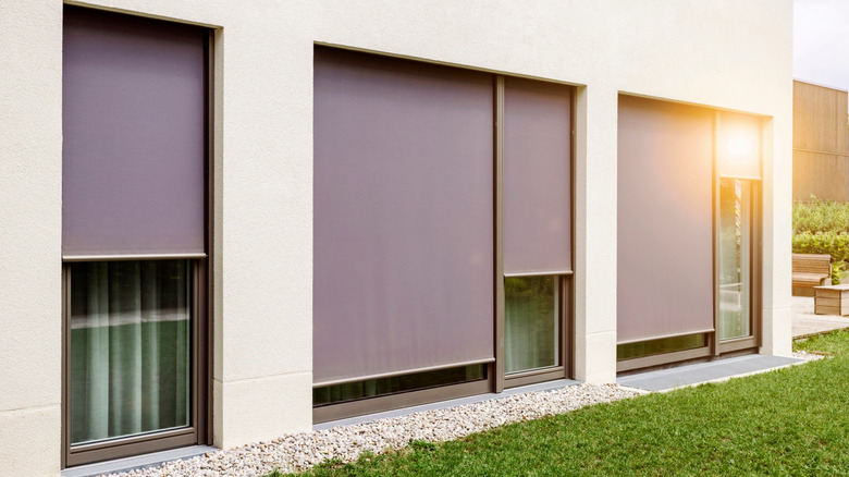 Exterior shades covering large windows on outside of home