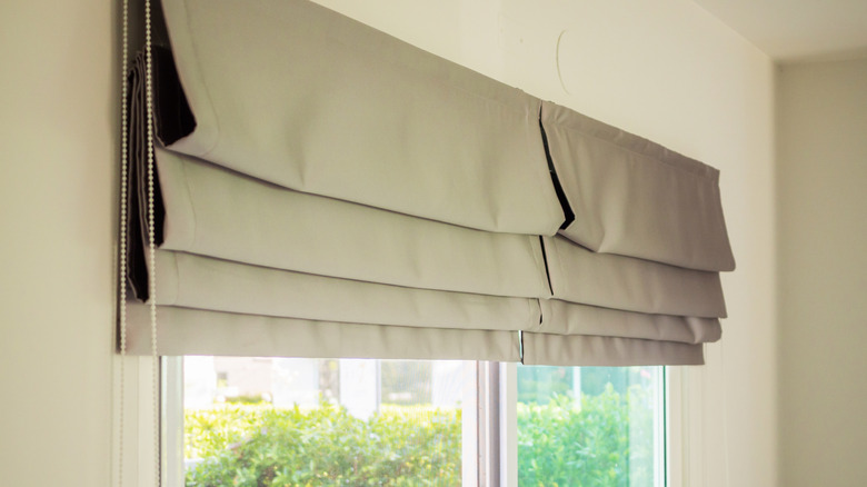 Roman shades mounted over glass doors