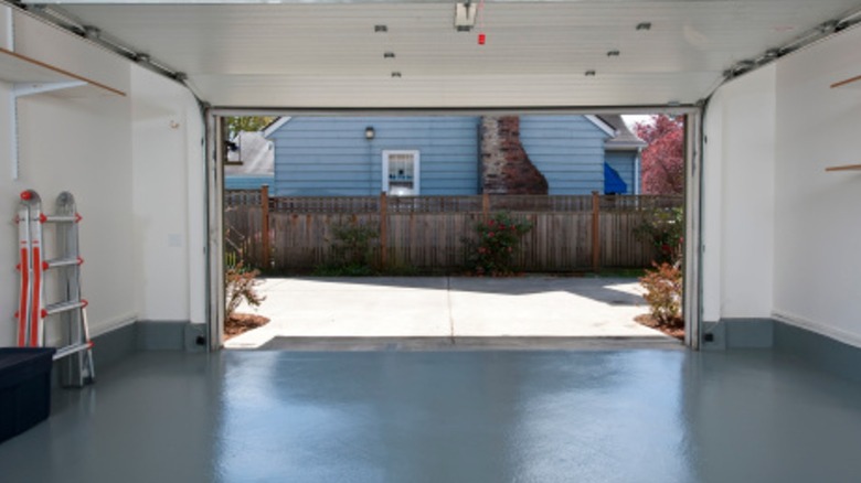 A view from inside a large house garage with rubber flooring
