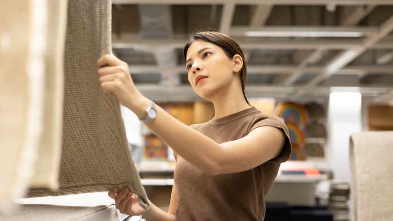 Woman looking at rugs at the store