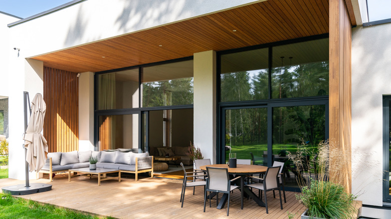 Modern home with wood decking and patio furniture