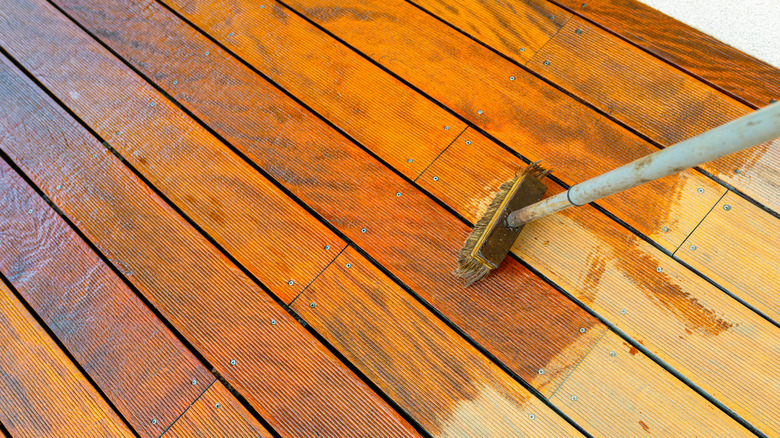 Close up of wooden decking being treated