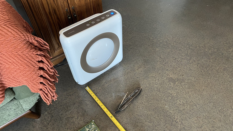 Coway Airmega Mighty AP-1512HH air purifier beside burning incense and measuring tape.