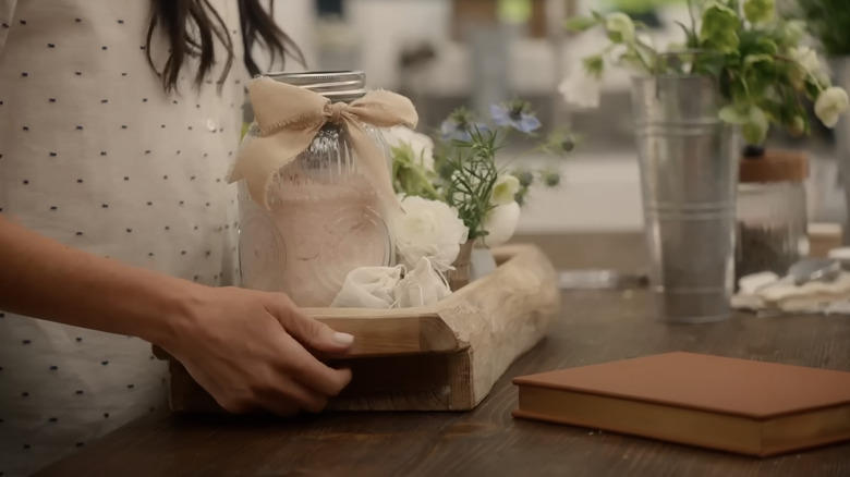 Meghan Markle holds a tray full of homemade gifts and flowers
