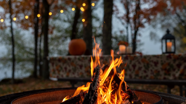 String lights hang above a roaring firepit