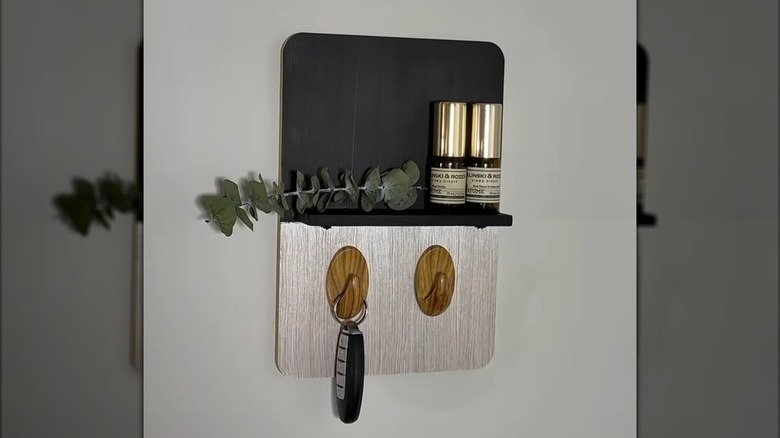 Black and white wooden key holder for entryway hung on wall