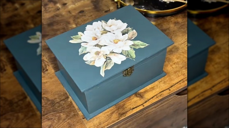DIYer shows off their newly-crafted vintage-inspired storage box.