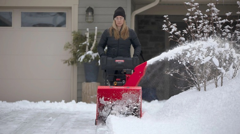 Woman using a Craftsman snow blower