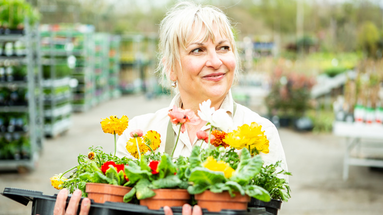 Person holding flowers at a garden center