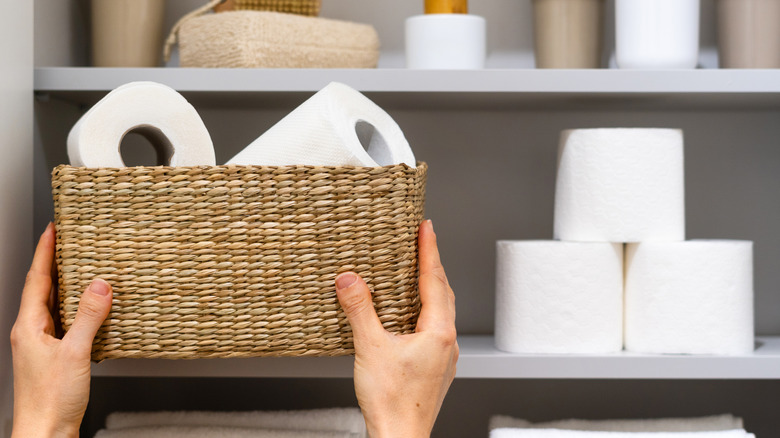 Toilet paper stored on a shelf and in a basket