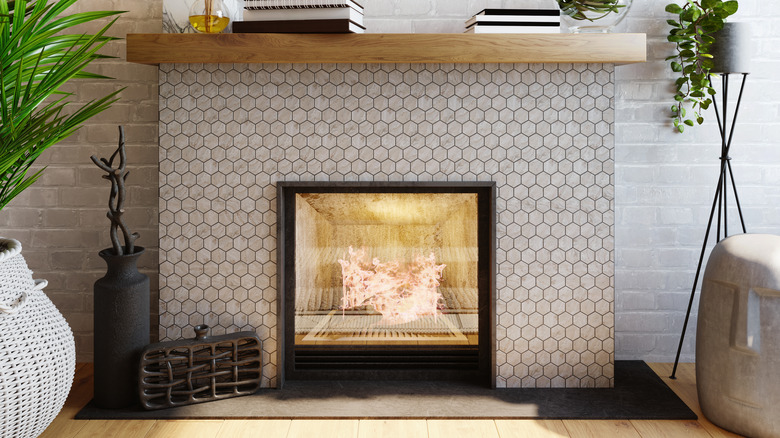 The fireplace is lined with hexagonal tiles in the interior.
