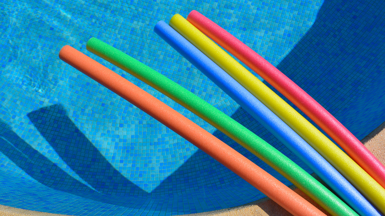 Pool noodles laying across pool