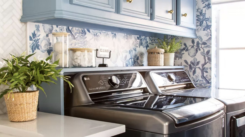 Laundry room with blue shelf behind washer and dryer