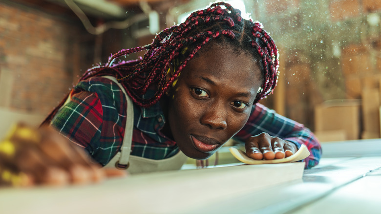 woman sanding wood