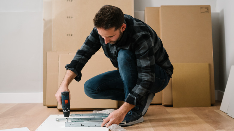 man assembling furniture