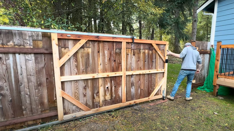 Person sliding fence closed