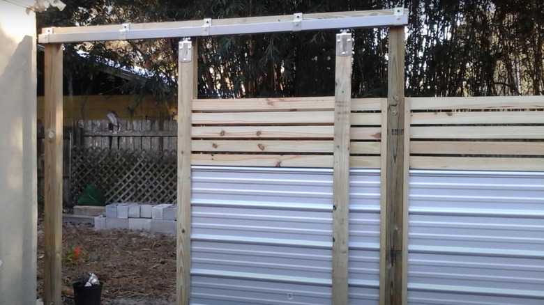 Barn door fence gate made from wood and metal