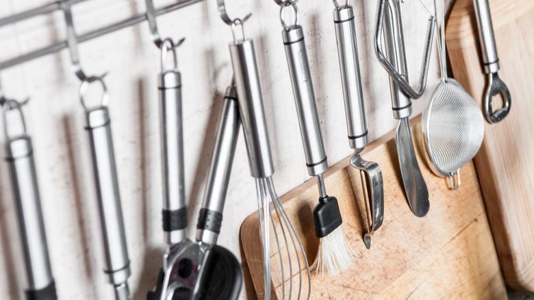 Kitchen utensils on a wall rack