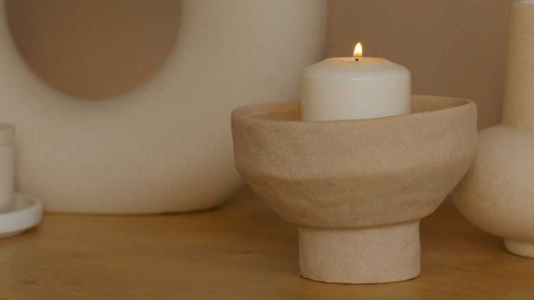 White candle in stone holder
