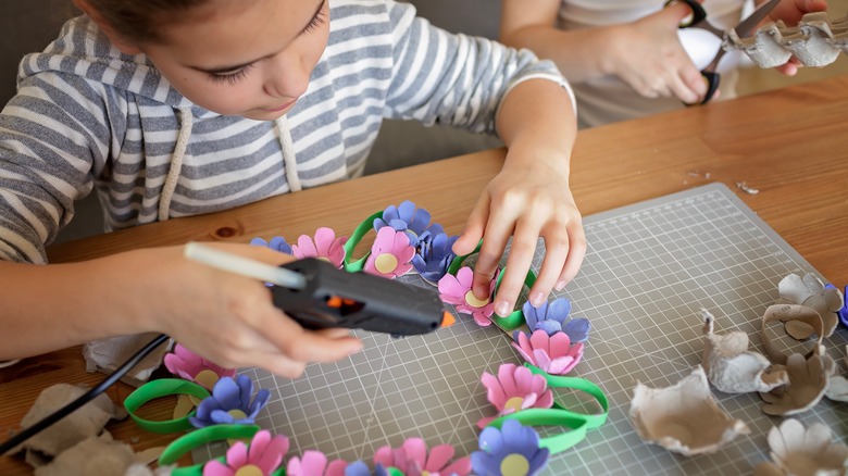 Little girl making a spring wreath 