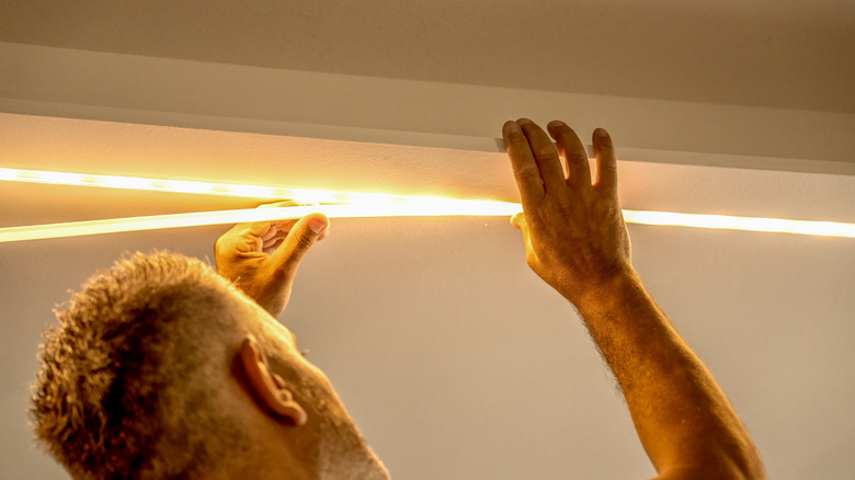 Person installing LED strip lights