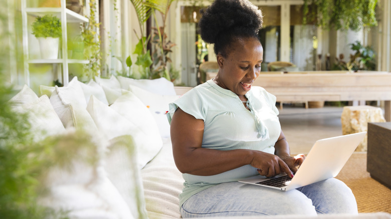 A woman sitting in a sunroom