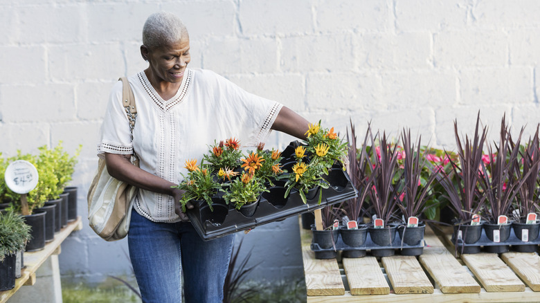 woman with tray of flowers